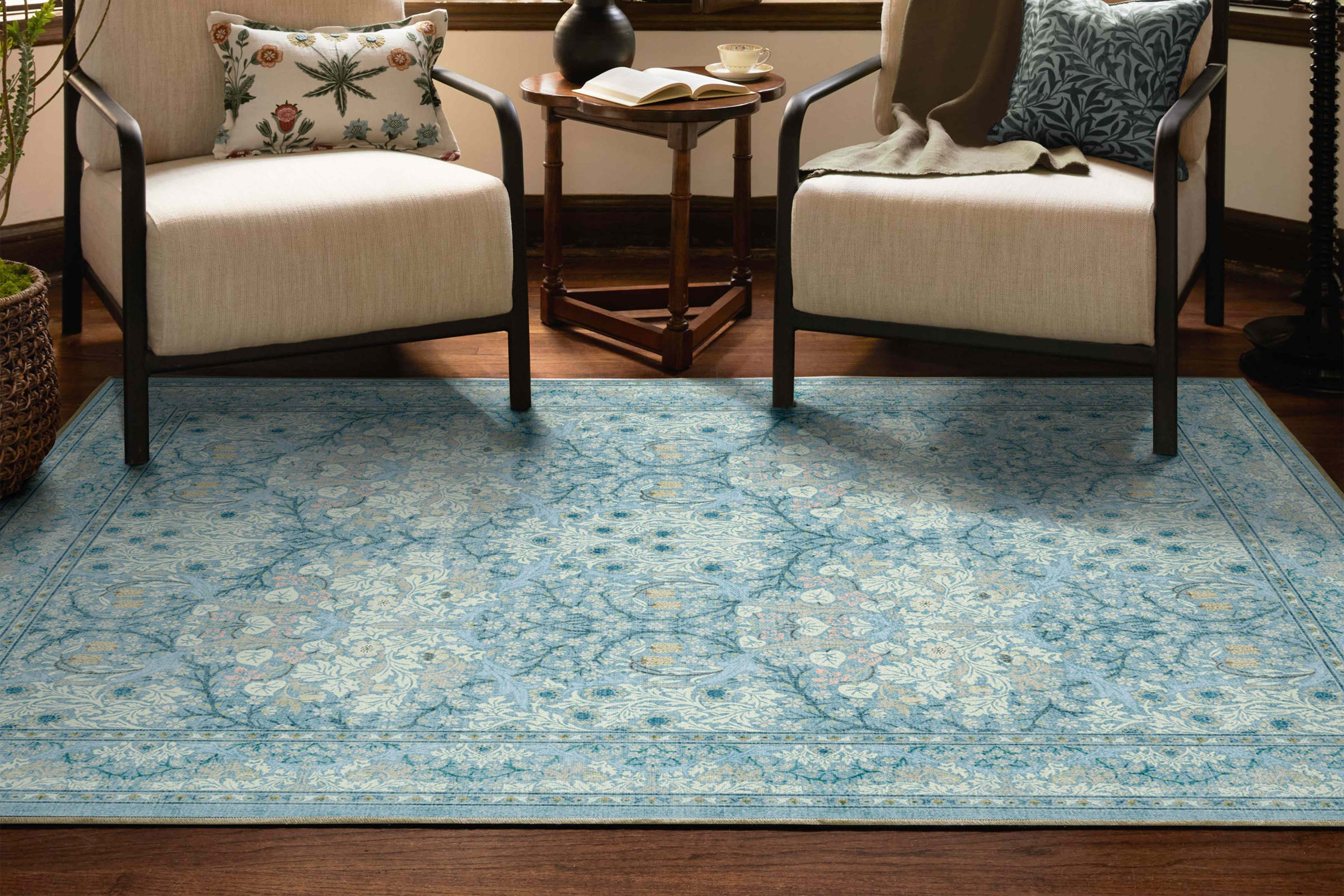 Two chairs and a small table on an ornate rug in a room setting Credit: Ruggable