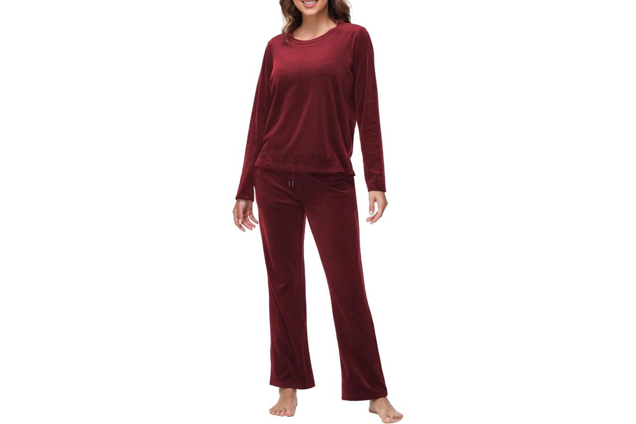 Person modeling a velour sweatsuit with long sleeves and pants standing barefoot Credit: Amazon