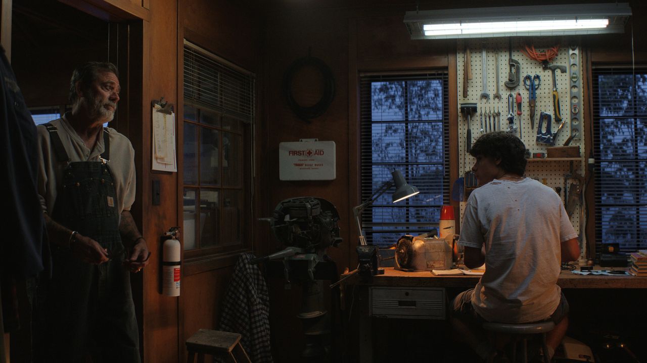 Jeffrey Dean Morgan standing in a workshop doorway another person seated at a workbench Jeffrey Dean Morgan as Joe and Jacob Whiteduck-Lavoie as Ellis on ‘Sterling Point’Credit: Prime Video