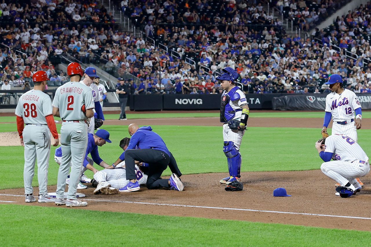 Jared Young of the New York Mets is taken off the field after a collision Jared Young of the New York Mets is taken off the field after a collisionCredit: Jim McIsaac/Getty