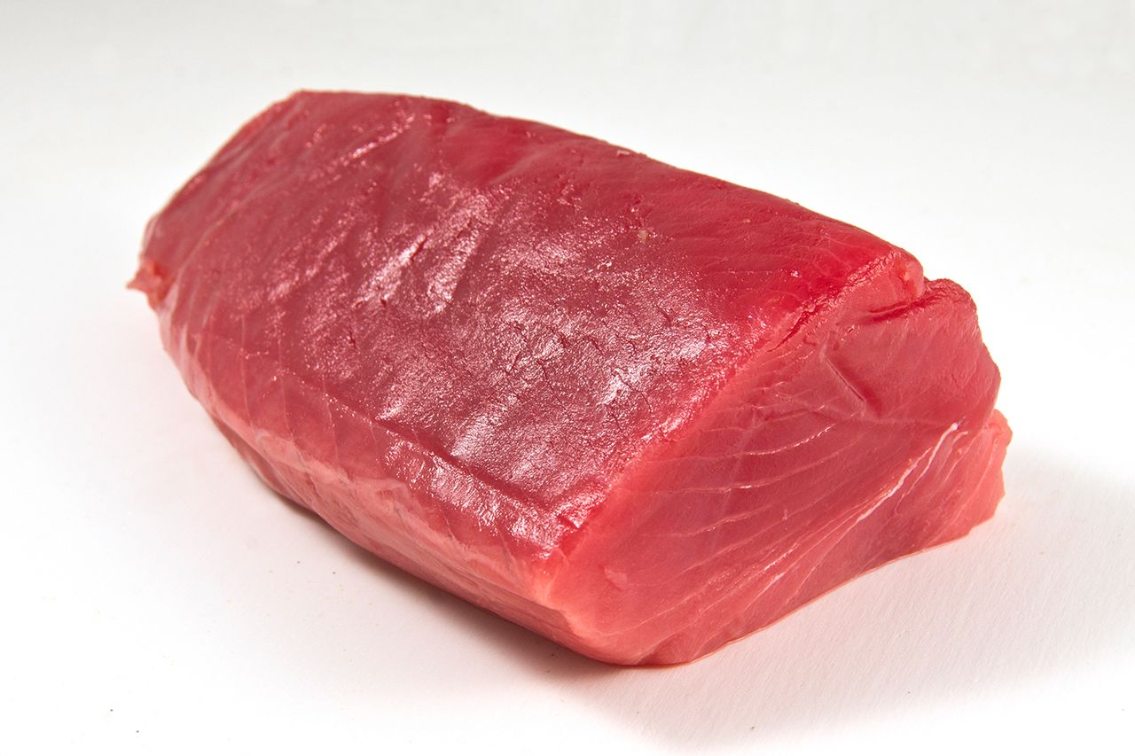 Tuna fillet, white background. (Stock Image) Scombroid poisoning typically results in allergic reaction-like symptoms, per the FDACredit: Getty