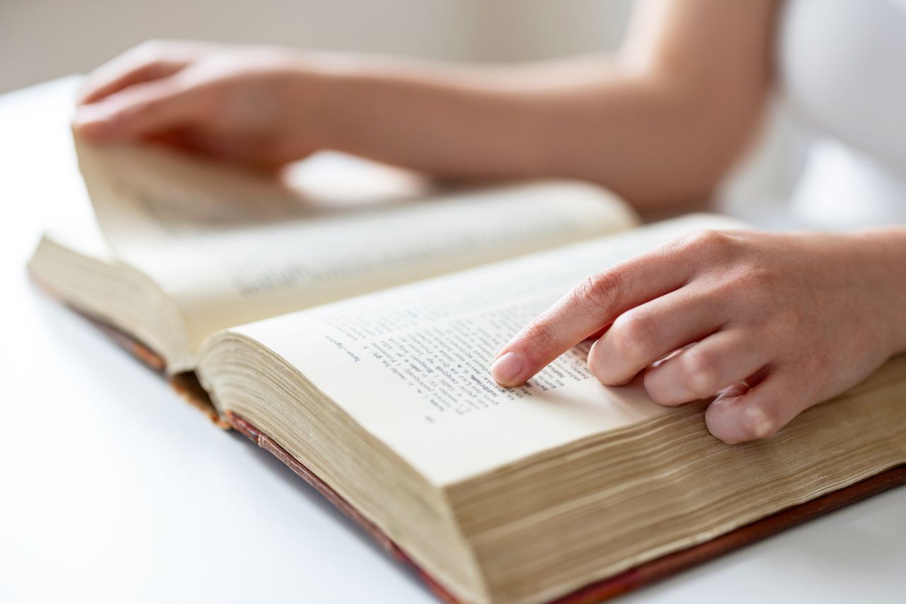 person tracing lines of text with their finger Woman reading a book (stock image)Credit: Getty