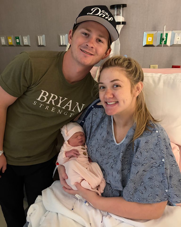 A mother holds a newborn baby in a hospital bed with a man standing beside them Abby Wilson and her familyCredit: Courtesy of Abby Wilson