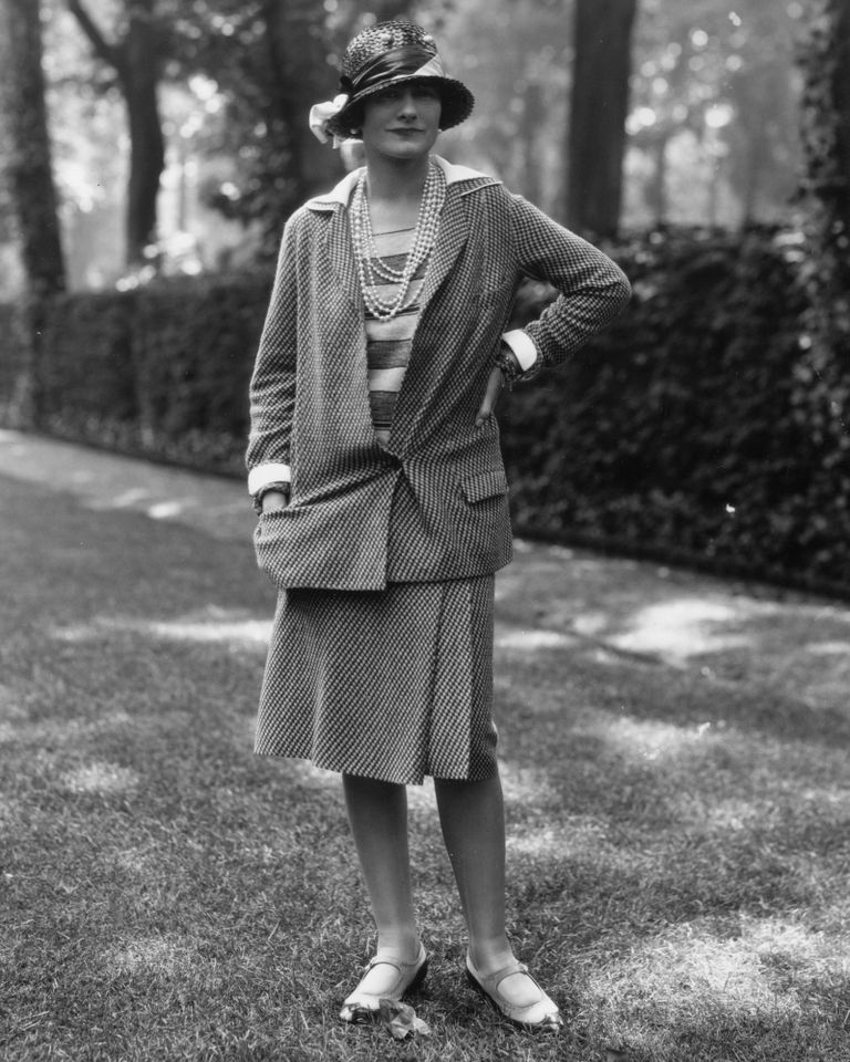 30th May 1929: Influential French fashion designer Coco Chanel, real name Gabrielle Bonheur Chanel, (1883 - 1971) modelling a Chanel suit at Fauborg, St Honore, Paris. Coco Chanel in 1929.Credit: Sasha/Hulton Archive/Getty