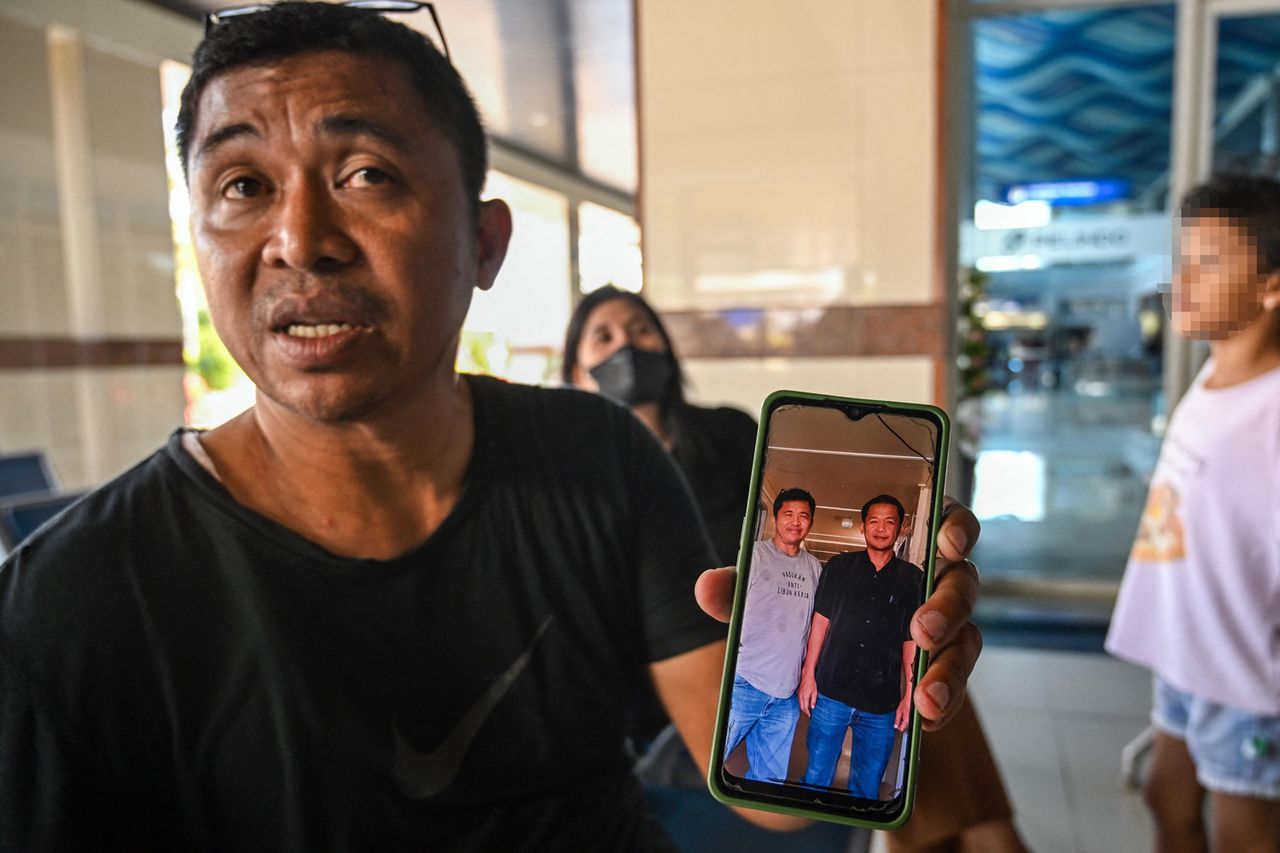 Fredy Manuhua shows a picture of his brother who was a passenger on Virgo Transport 8, carrying 243 people, which met with an accident en route from Surabaya, East Java to Banjarmasin, South Kalimantan, as relatives seek information about loved ones at Tanjung Perak Port in Surabaya on September 13, 2026. Fredy Manuhua showing a picture of his brother who was a passenger on Virgo Transport 8Credit: JUNI KRISWANTO / AFP via Getty