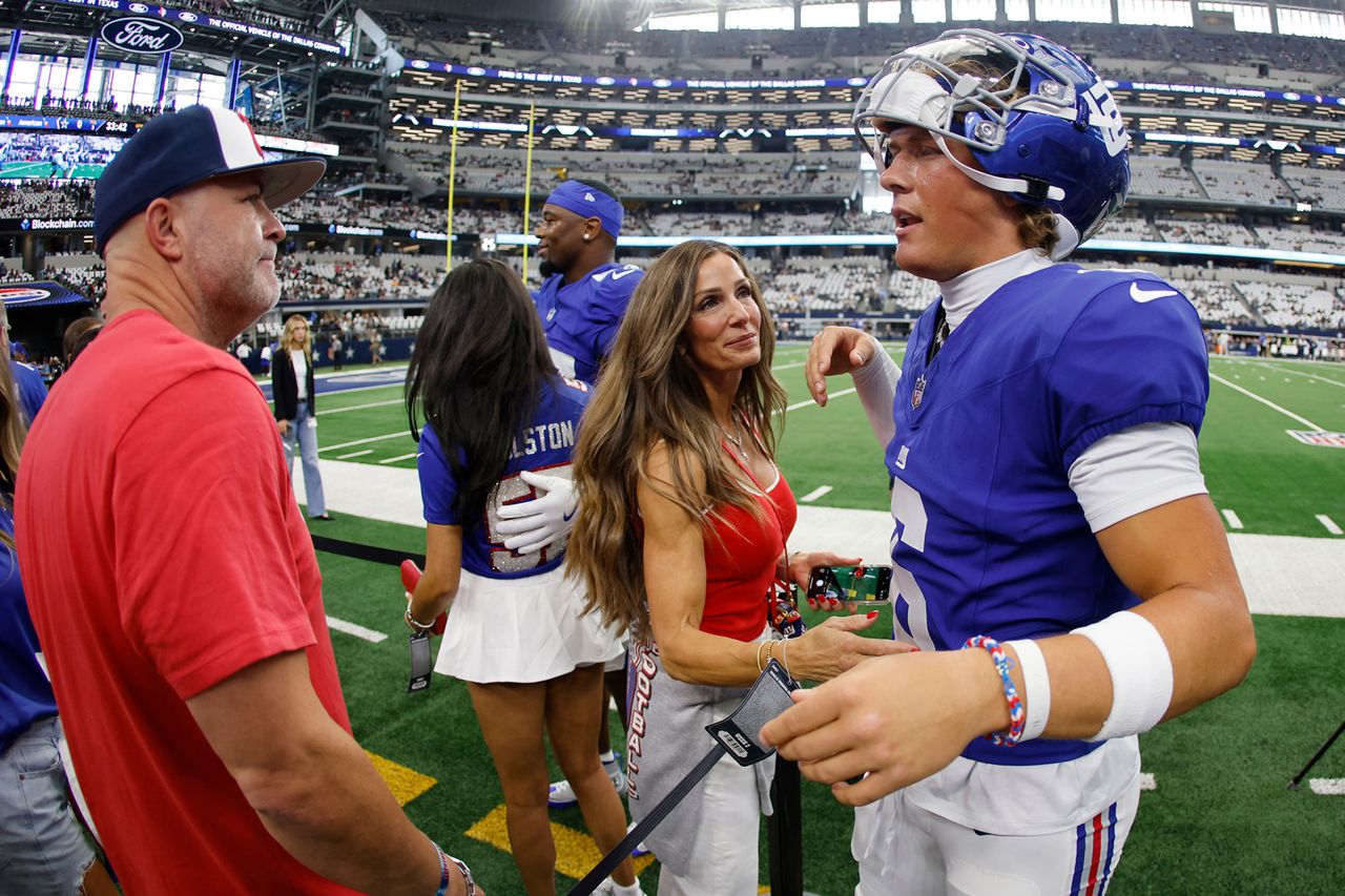 Jaxson Dart speaks with his parents prior to a game on September 14, 2025 in Arlington, TexasCredit: Ron Jenkins/Getty