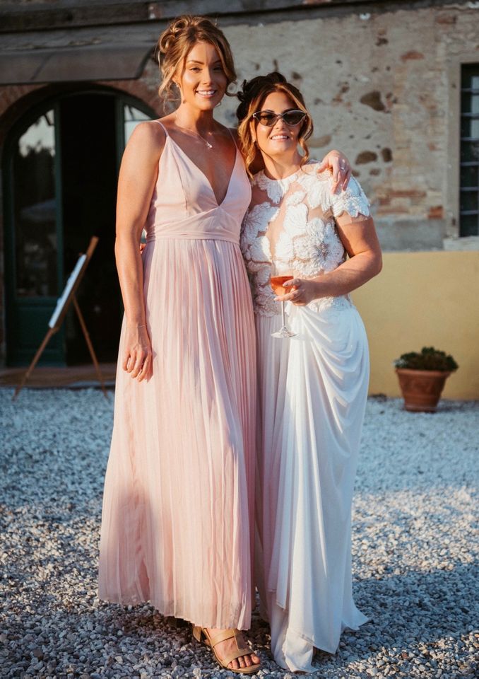 Katherine Jones, known online as @kathjay89 on TikTok, went viral after turning her canceled destination wedding into a three-day celebration with family and friends. Katherine Jones (R) with a guest on what would have been her wedding dayCredit: Simone Trebbi Studio of Pesaro
