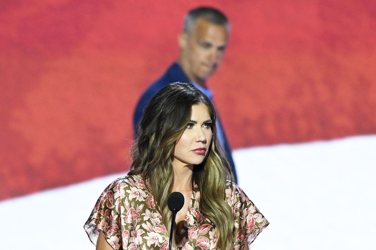 South Dakota Republican Governor Kristi Noem takes part in a sound check as political commentator Corey Lewandowski looks on at the Fiserv Forum ahead of the 2024 Republican National Convention on July 14, 2024 in Milwaukee, Wisconsin. The convention will take place from July 15th to the 18th. Corey Lewandowski behind Kristi Noem at the 2024 Republican National Convention on July 14 in Milwaukee.Credit: ANDREW CABALLERO-REYNOLDS/AFP via Getty