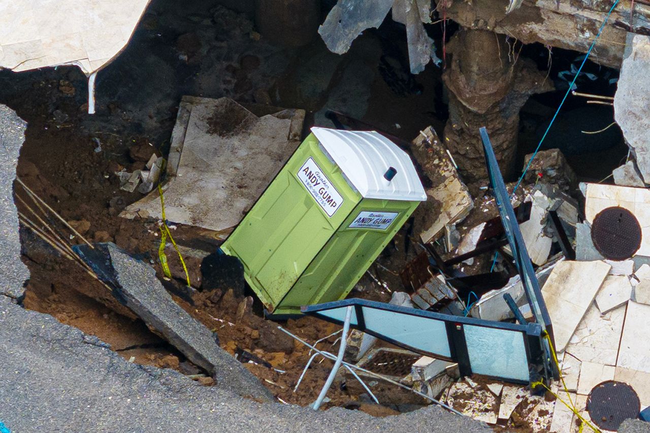 A portable toilet resting in a collapsed outdoor area surrounded by rubble and construction debris Massive sinkhole outside of Nicolas Cage’s home in Malibu, Calif., on Sept. 8, 2026Credit: BACKGRID