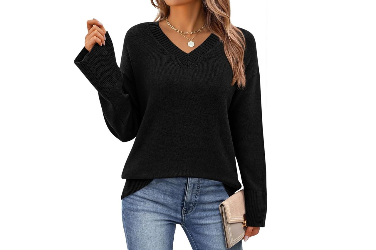 A model wearing a Vneck sweater and holding a clutch Credit: Amazon
