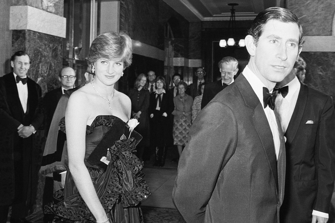 London, England: Lady Diana Spencer, wearing a low cut gown follows Prince Charles into the Goldsmiths' Hall for a special performance of Prince Charles and a then-Lady Diana Spencer in an undated photo taken during their engagement.Credit: Getty