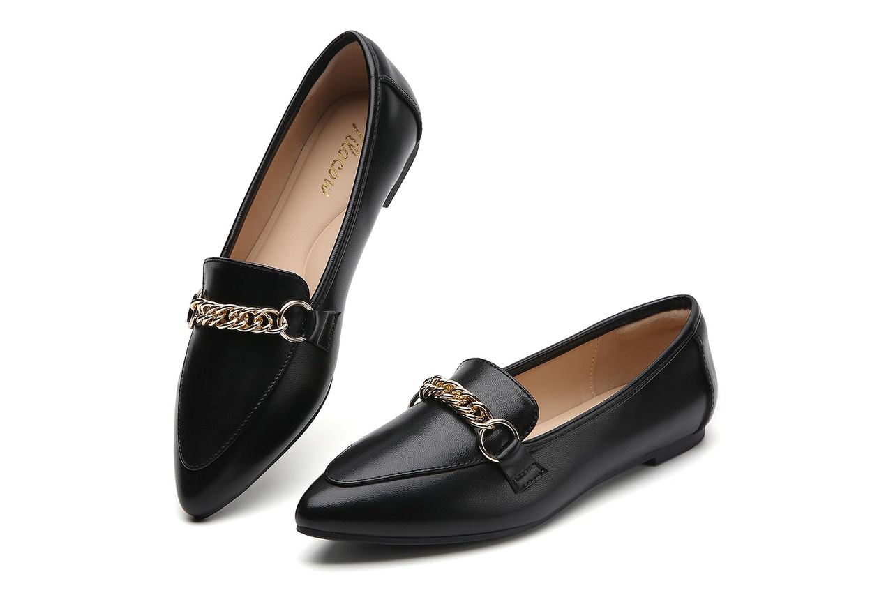 A pair of womens black pointedtoe loafers with decorative chains Credit: Amazon